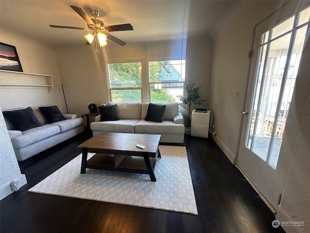 living room featuring ceiling fan, a wealth of natural light, and hardwood / wood-style floors