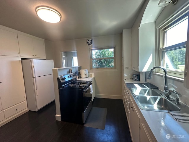 kitchen featuring white cabinets, dark wood-type flooring, white fridge, sink, and range with electric stovetop