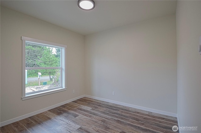 empty room with wood finished floors and baseboards