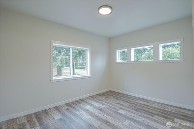 unfurnished room with light wood-style floors and baseboards