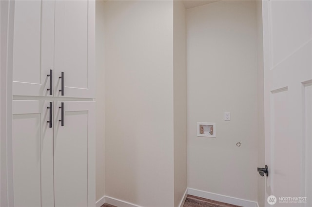 laundry area featuring laundry area, baseboards, washer hookup, and wood finished floors