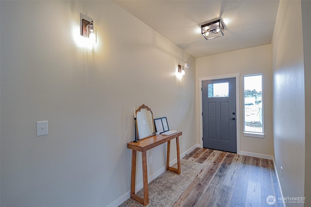 foyer entrance featuring light wood-style floors and baseboards