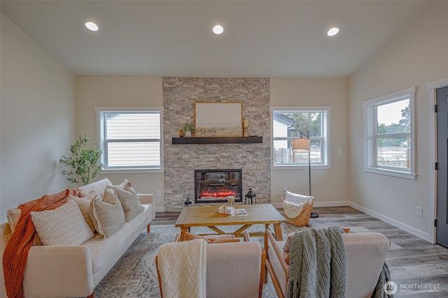 living room with a healthy amount of sunlight, wood finished floors, and recessed lighting