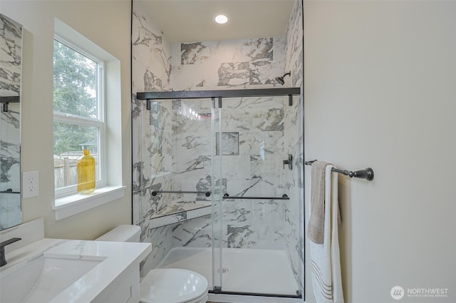 full bathroom featuring vanity, a marble finish shower, and toilet