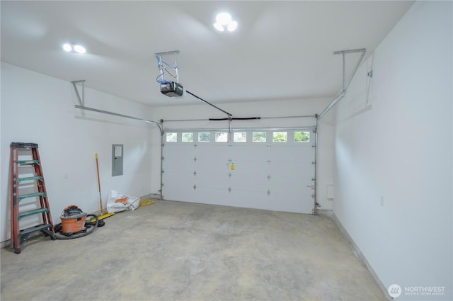 garage featuring electric panel and a garage door opener