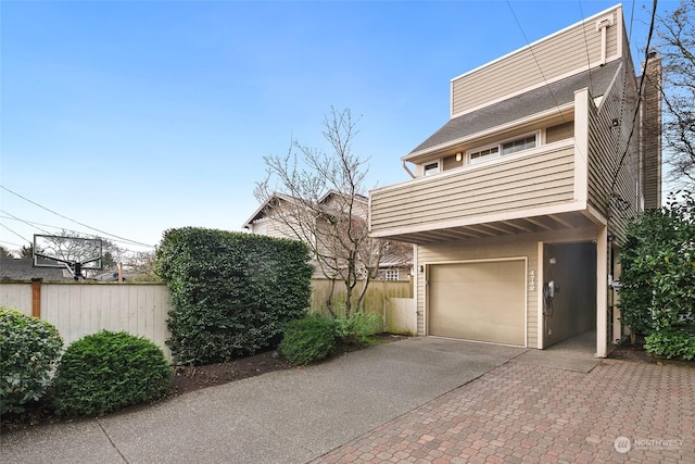 view of front facade with a balcony and a garage