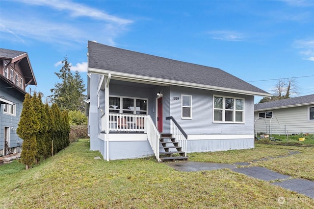 view of front of property with covered porch and a front yard