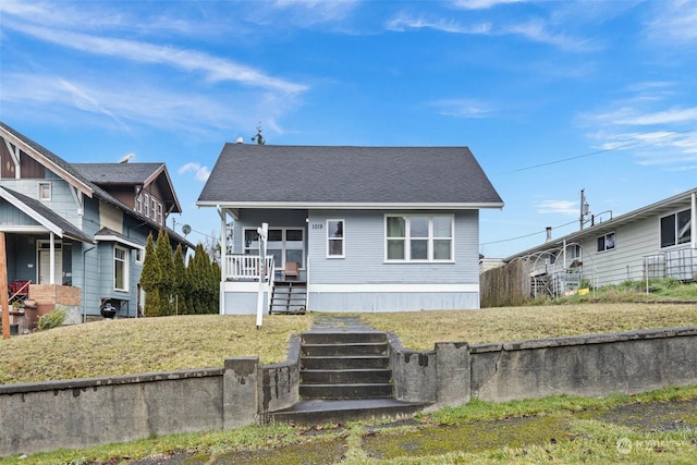 view of front of property featuring a porch and a front lawn