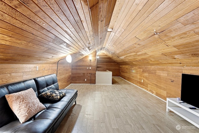 interior space featuring wood walls, wooden ceiling, hardwood / wood-style floors, and lofted ceiling