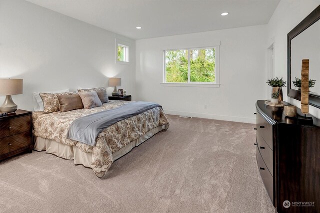 bedroom featuring light carpet, baseboards, and recessed lighting