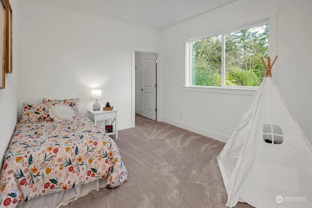 bedroom with carpet and baseboards