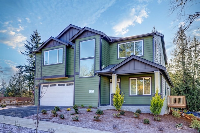 craftsman house featuring a garage, driveway, and board and batten siding