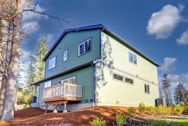 rear view of property with cooling unit and a deck