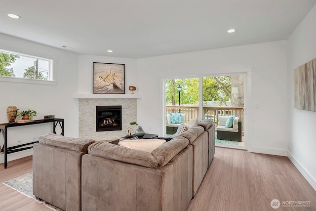 17018 106th Ave SE Unit 11, Renton, WA 98055 - living area featuring light wood finished floors, a lit fireplace, baseboards, and recessed lighting