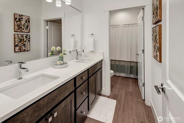 17018 106th Ave SE Unit 11, Renton, WA 98055 - full bath with toilet, wood finished floors, double vanity, a shower with curtain, and baseboards