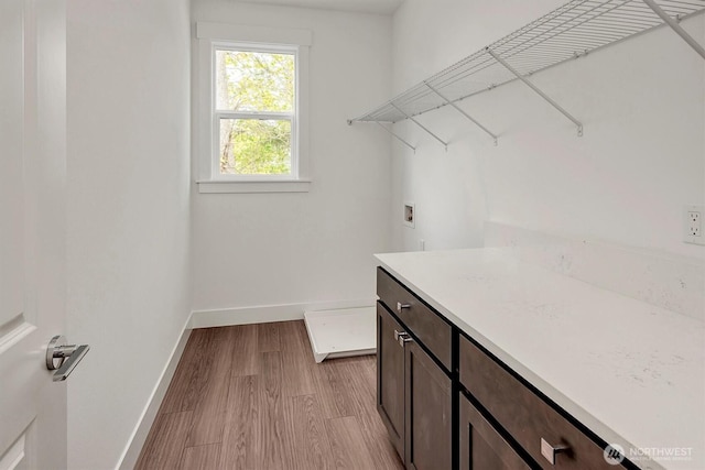 17018 106th Ave SE Unit 11, Renton, WA 98055 - laundry room featuring hookup for a washing machine, baseboards, and light wood finished floors