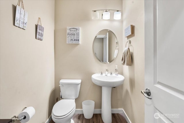 bathroom with sink, toilet, and wood-type flooring