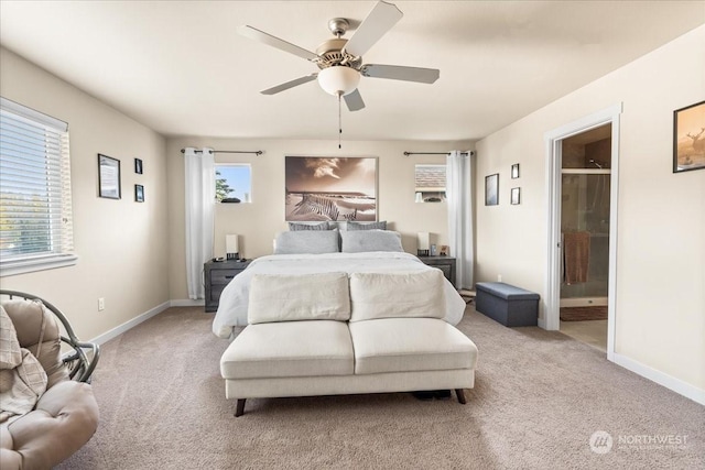 bedroom with ceiling fan, light carpet, and ensuite bath