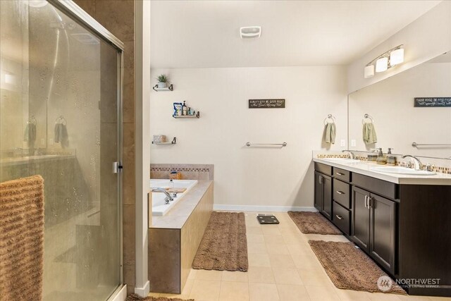 bathroom featuring shower with separate bathtub, vanity, and tile patterned flooring