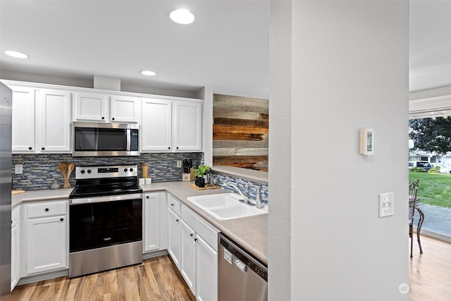 kitchen featuring sink, white cabinets, and stainless steel appliances