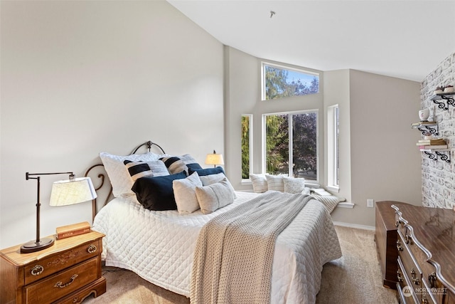 carpeted bedroom with lofted ceiling