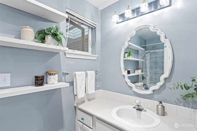 bathroom featuring vanity and a tile shower