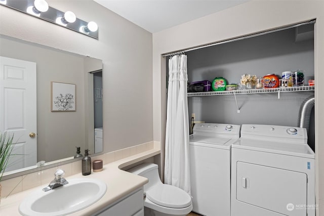 bathroom with separate washer and dryer, toilet, and vanity