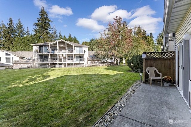 view of yard with a balcony