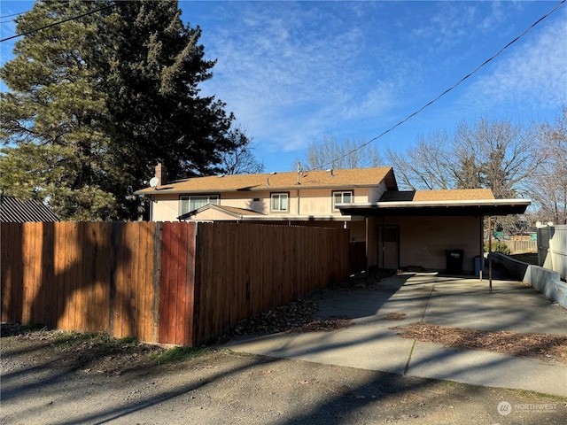 back of house with a carport