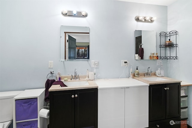 bathroom with toilet and vanity