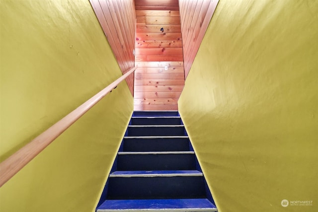 staircase with wooden walls