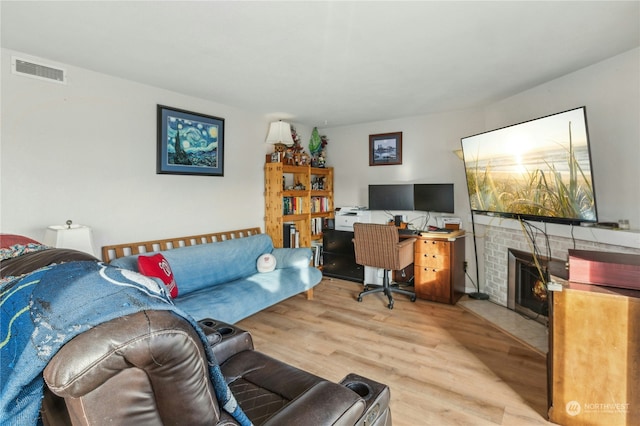 living room with a fireplace and hardwood / wood-style flooring