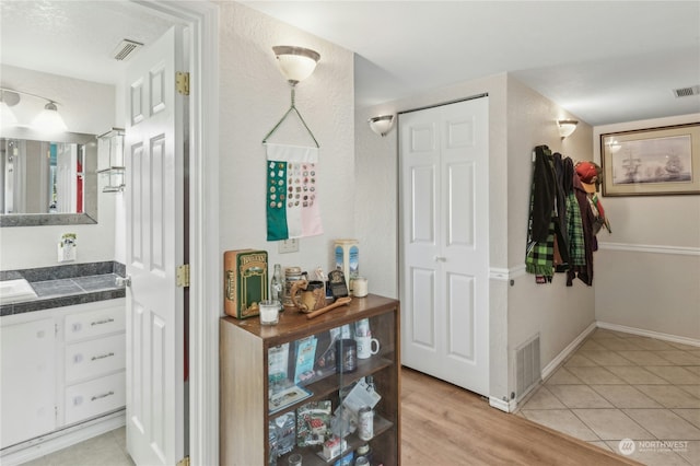 corridor with light tile patterned floors