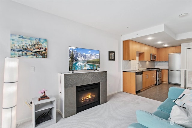 living room featuring light carpet and sink