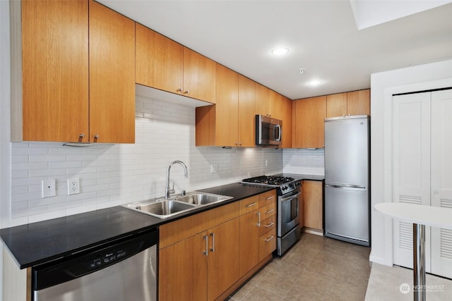 kitchen featuring sink, decorative backsplash, stainless steel appliances, and light tile patterned floors