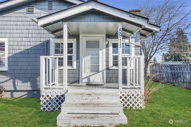 entrance to property with a lawn