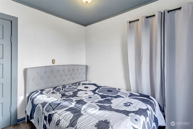 bedroom with wood-type flooring