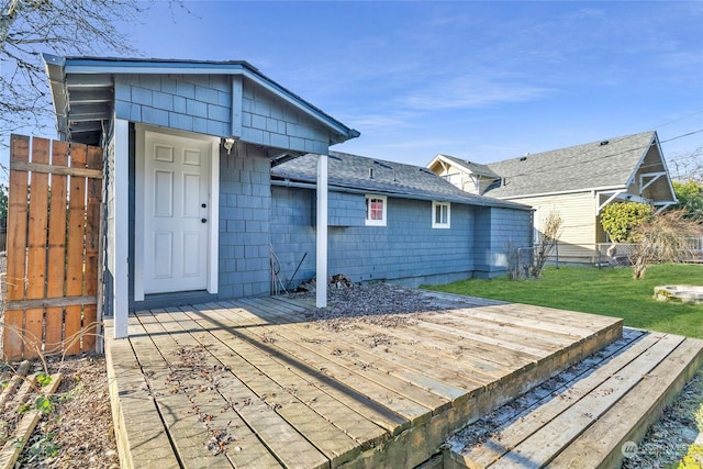 wooden terrace featuring a yard