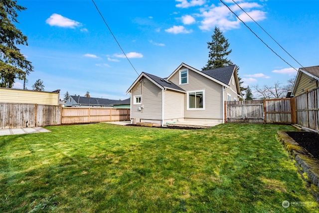 rear view of house with a patio and a yard