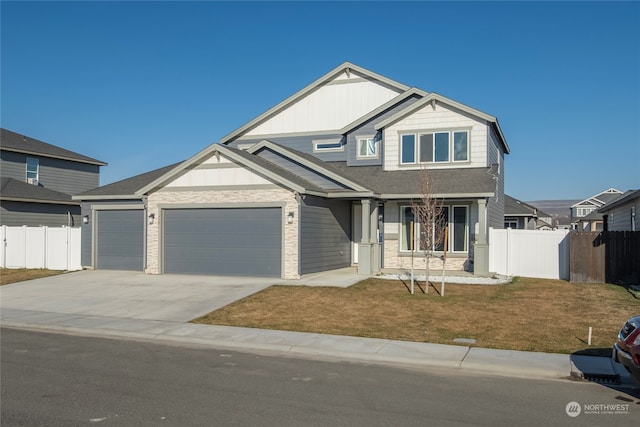 craftsman-style house featuring a garage and a front yard