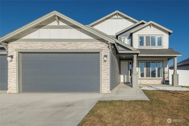 craftsman inspired home featuring a garage and a front lawn