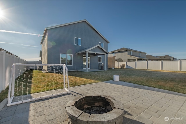 back of property featuring a patio area and an outdoor fire pit