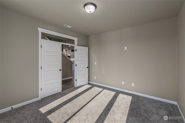 unfurnished bedroom featuring carpet floors and a closet