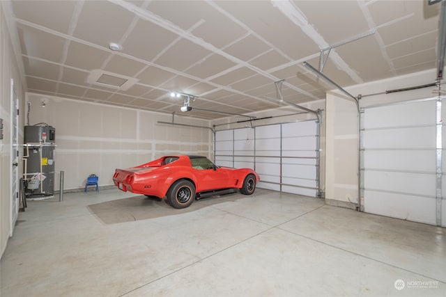 garage featuring a garage door opener and water heater