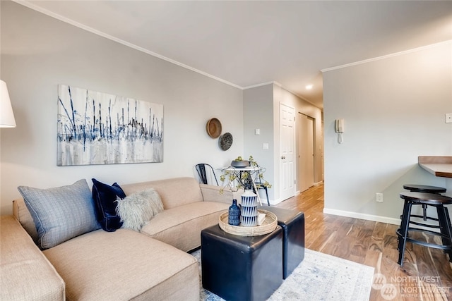 living room with wood-type flooring and ornamental molding