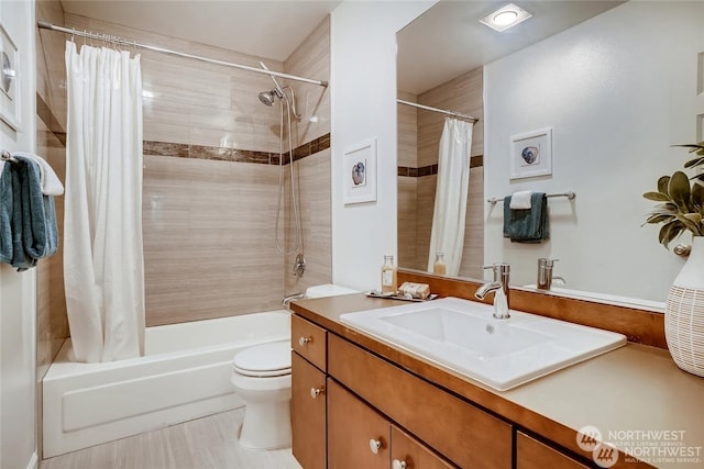 full bathroom with vanity, toilet, shower / bath combo with shower curtain, and tile patterned flooring