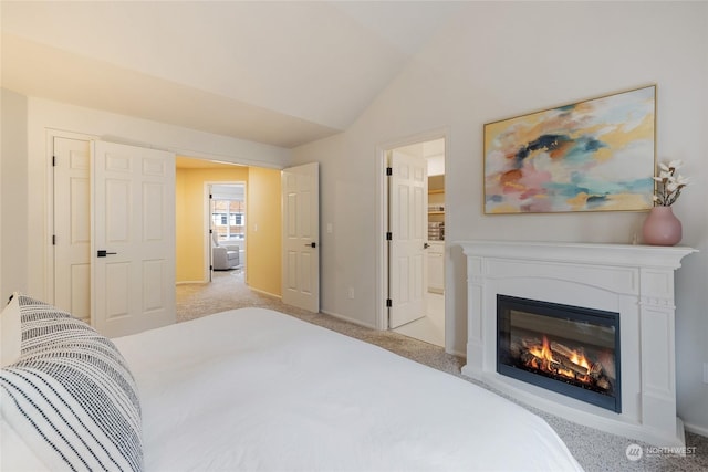 carpeted bedroom with vaulted ceiling