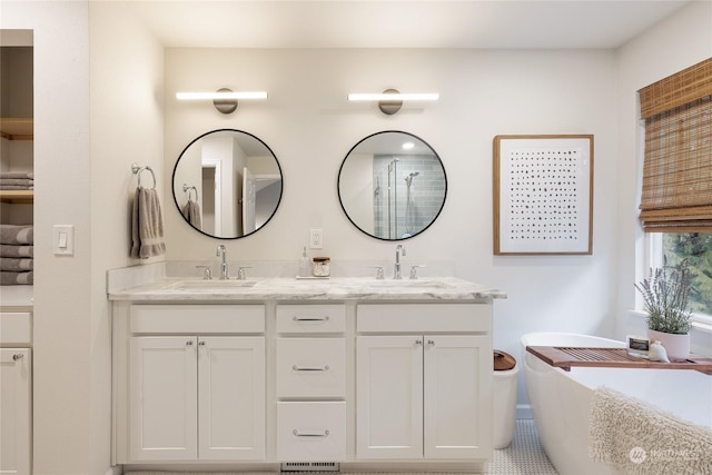 bathroom featuring vanity and a tub