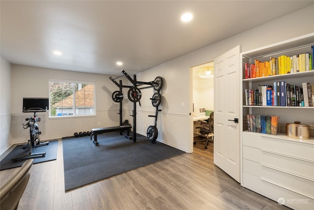 workout area with hardwood / wood-style floors