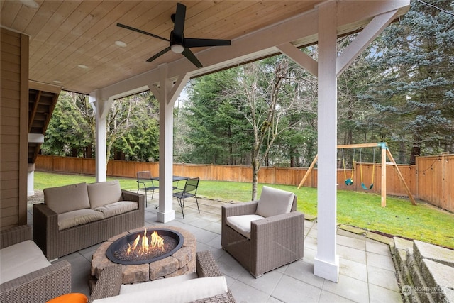 view of patio / terrace featuring a playground and an outdoor living space with a fire pit